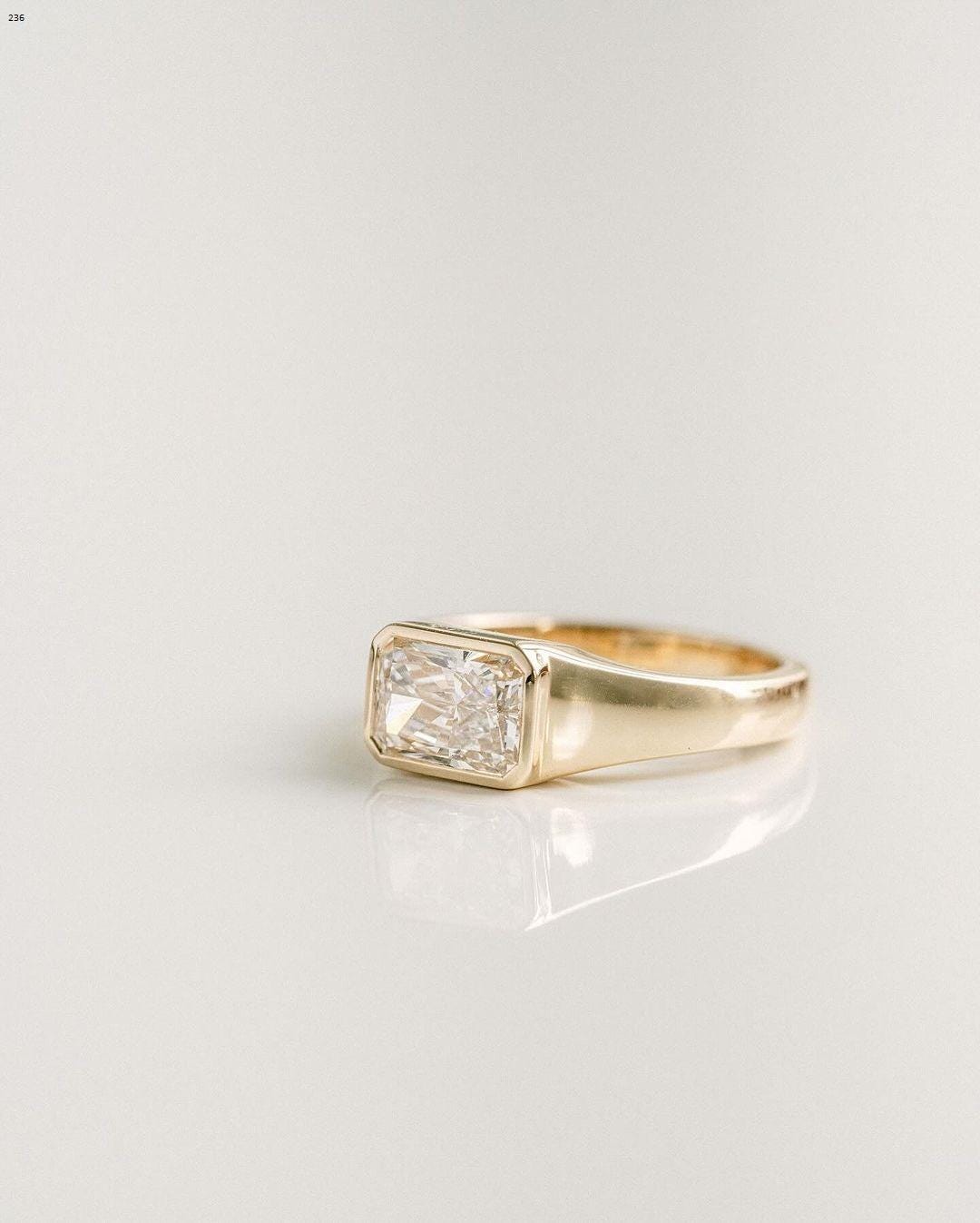 1.90CT Radiant Cut East-West Signet Ring gets a whiter and brighter look, 2.5mm yellow gold band, this solitaire offers best of both worlds